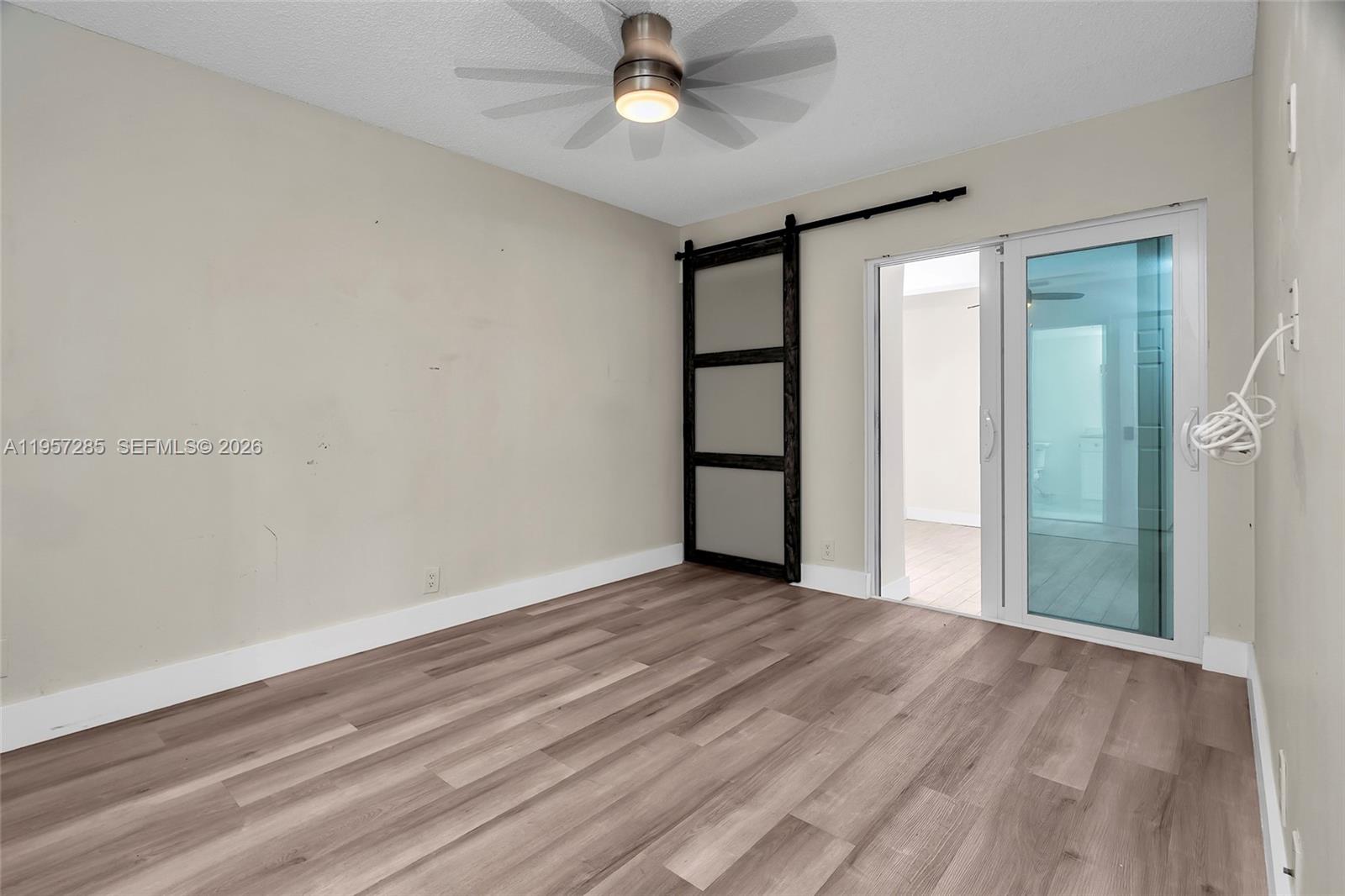 6768 Canary Palm Circle Boca Raton, FL 33433 - Photo 14 of 39 wooden floor in an empty room with a window