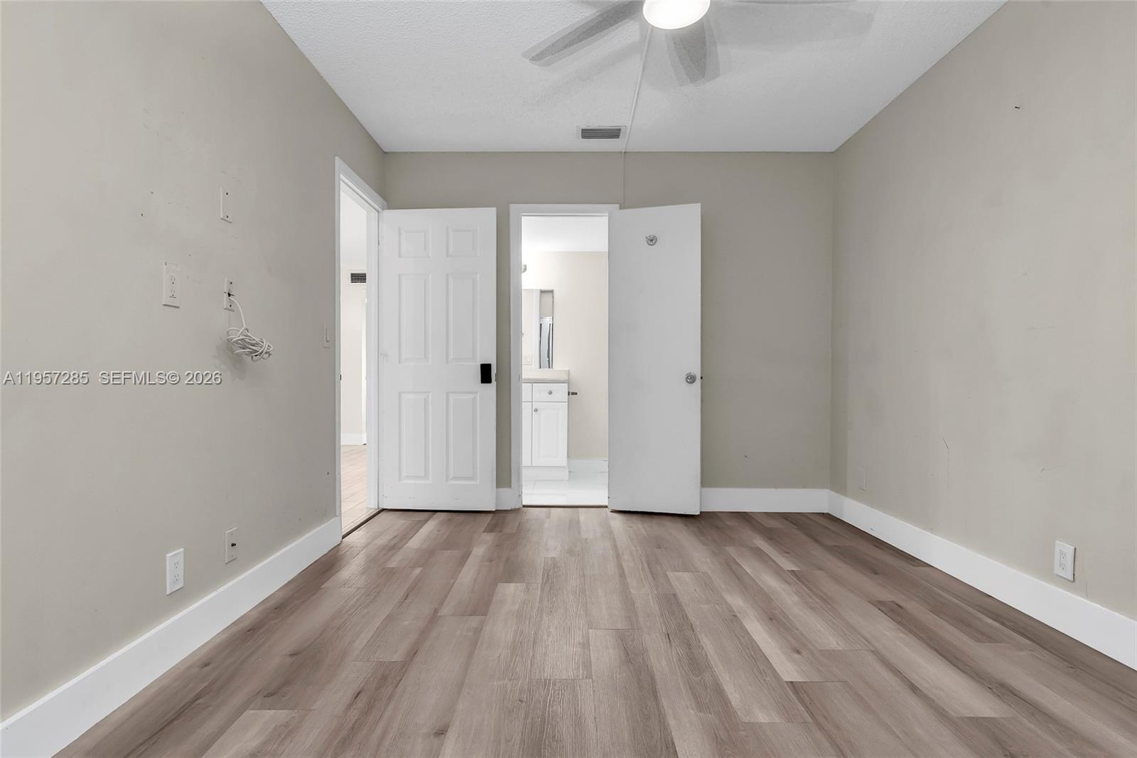 6768 Canary Palm Circle Boca Raton, FL 33433 - Photo 17 of 39 wooden floor in an empty room with a window