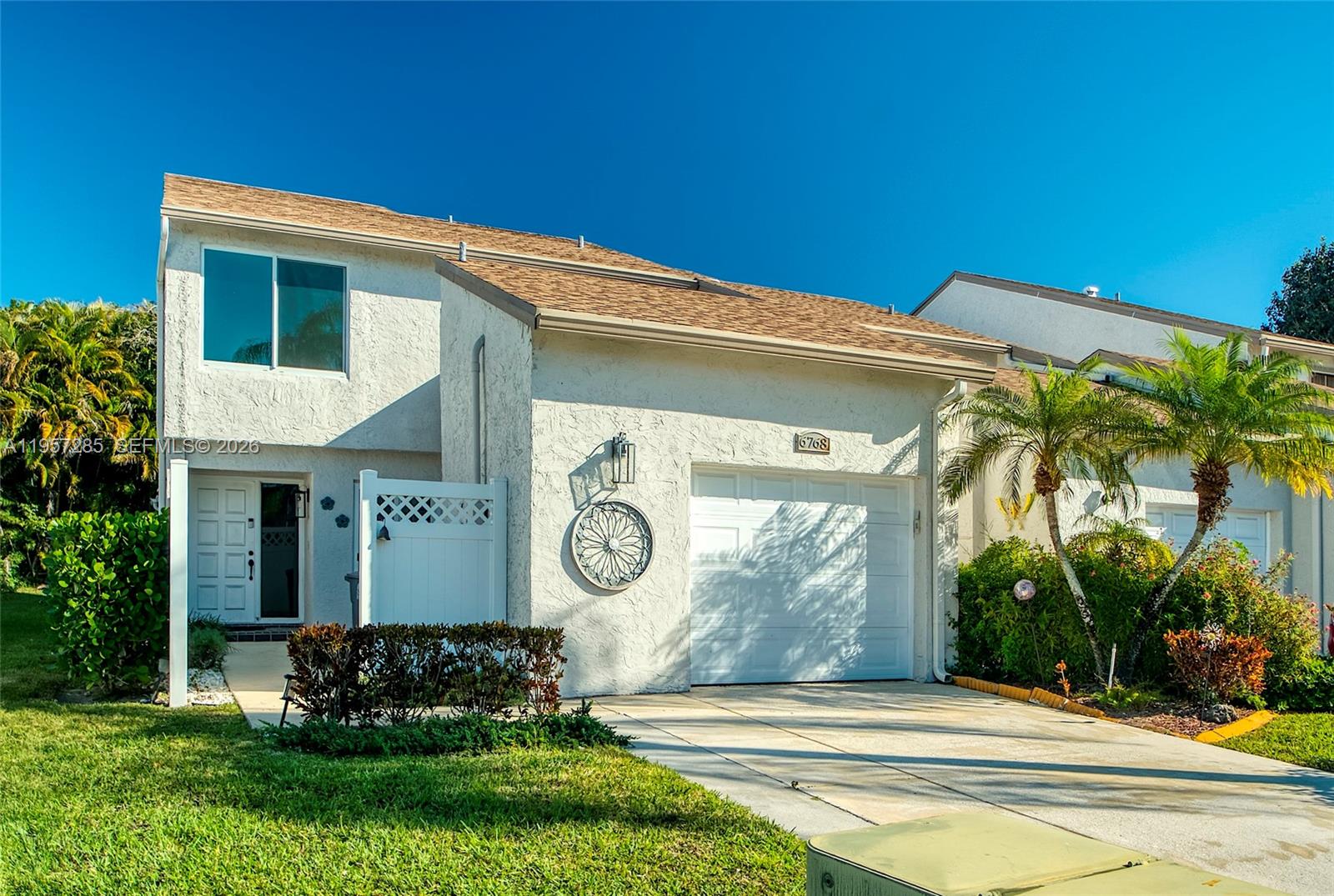 6768 Canary Palm Circle Boca Raton, FL 33433 - Photo 2 of 39 a front view of a house with garden