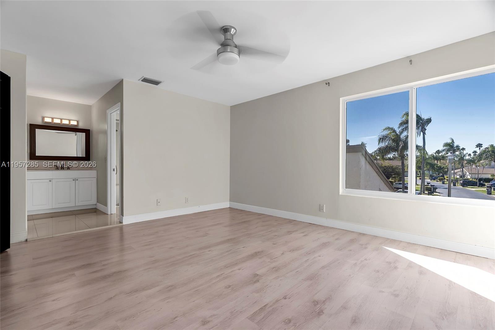 6768 Canary Palm Circle Boca Raton, FL 33433 - Photo 28 of 39 wooden floor in an empty room with a window