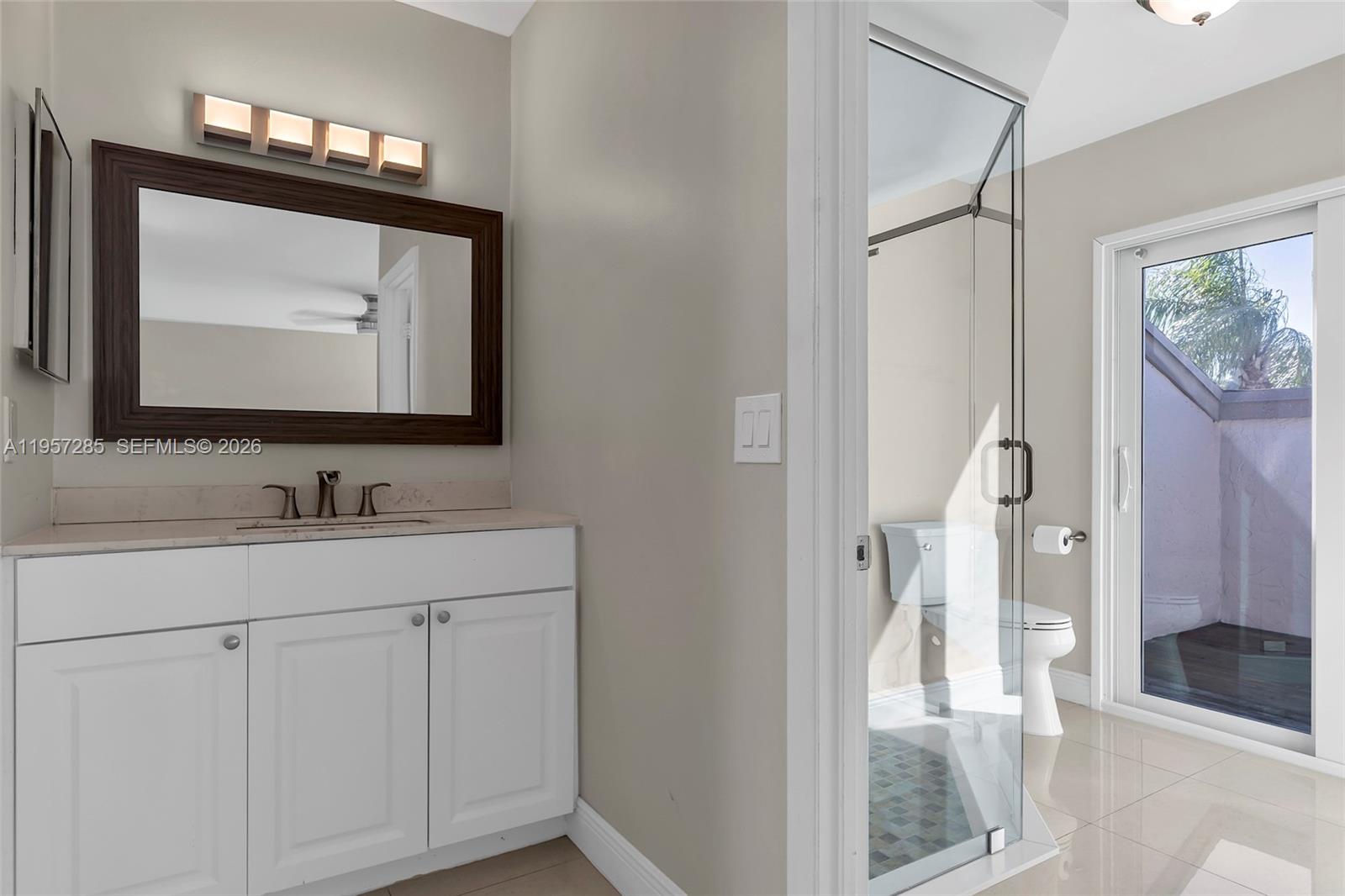 6768 Canary Palm Circle Boca Raton, FL 33433 - Photo 29 of 39 a bathroom with a sink vanity and a mirror