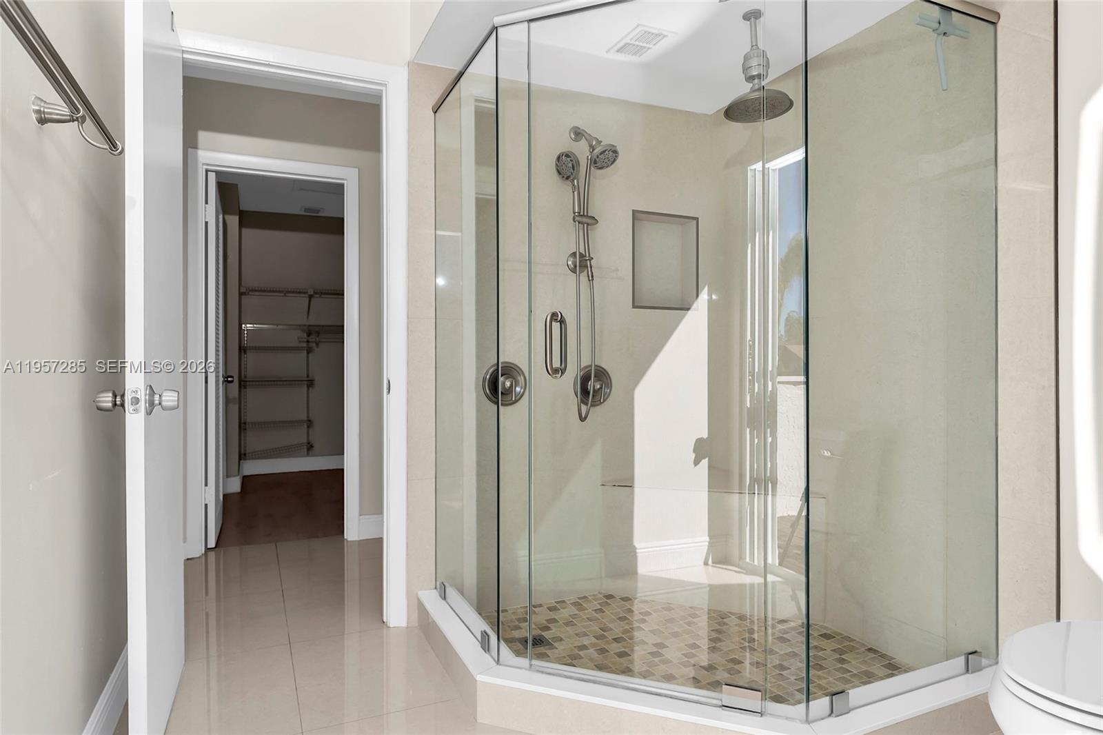 6768 Canary Palm Circle Boca Raton, FL 33433 - Photo 33 of 39 a bathroom with a glass shower door and a glass door