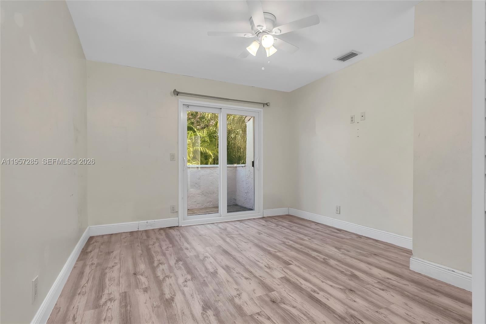 6768 Canary Palm Circle Boca Raton, FL 33433 - Photo 35 of 39 wooden floor in an empty room with a window