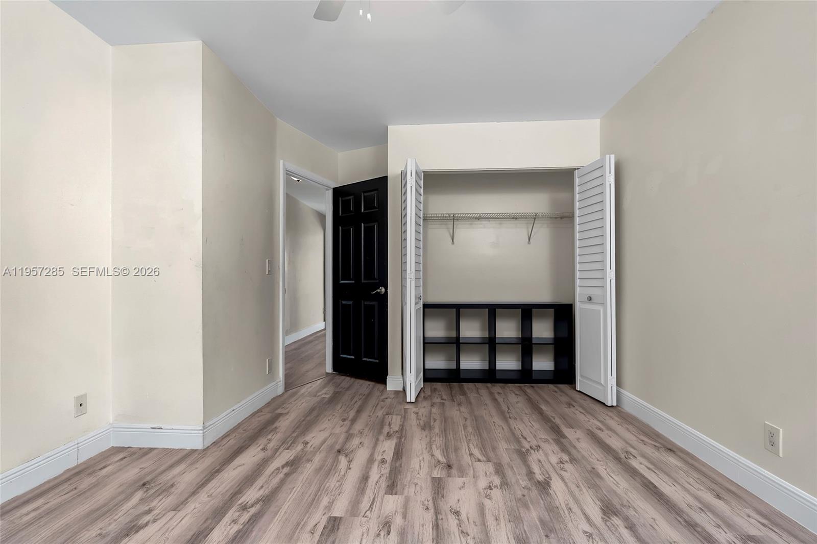 6768 Canary Palm Circle Boca Raton, FL 33433 - Photo 37 of 39 an empty room with closet and wooden floor