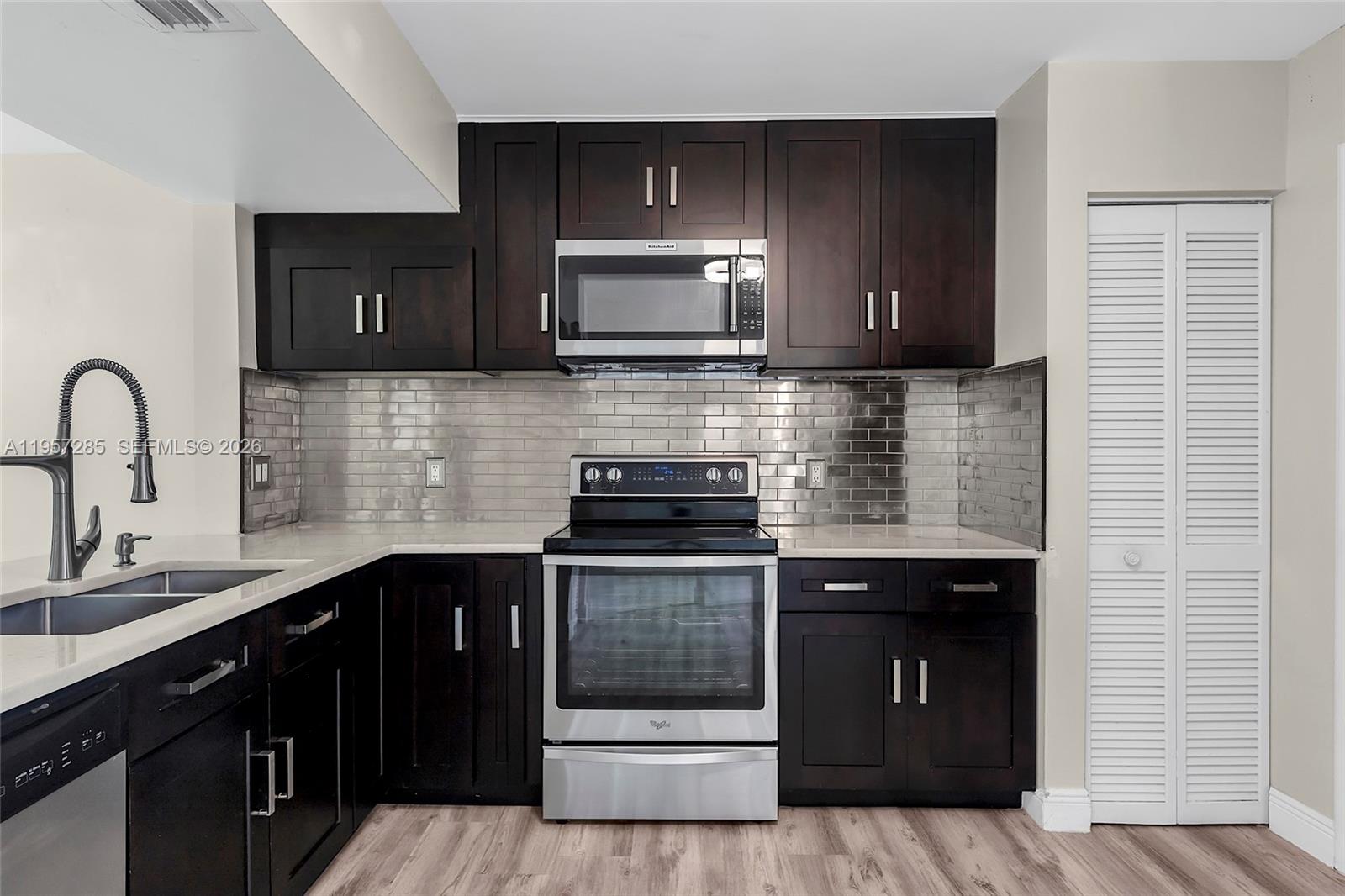 6768 Canary Palm Circle Boca Raton, FL 33433 - Photo 6 of 39 a kitchen with a stove and a sink