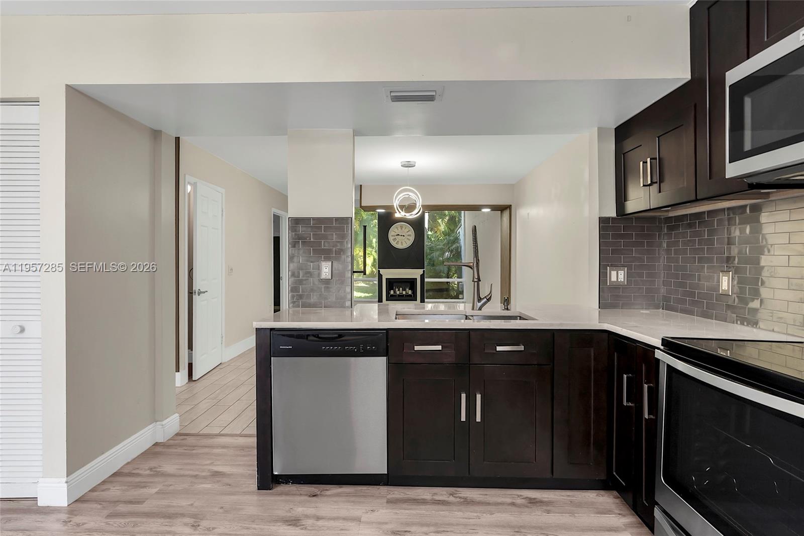 6768 Canary Palm Circle Boca Raton, FL 33433 - Photo 7 of 39 a kitchen with stainless steel appliances granite countertop a stove and a sink