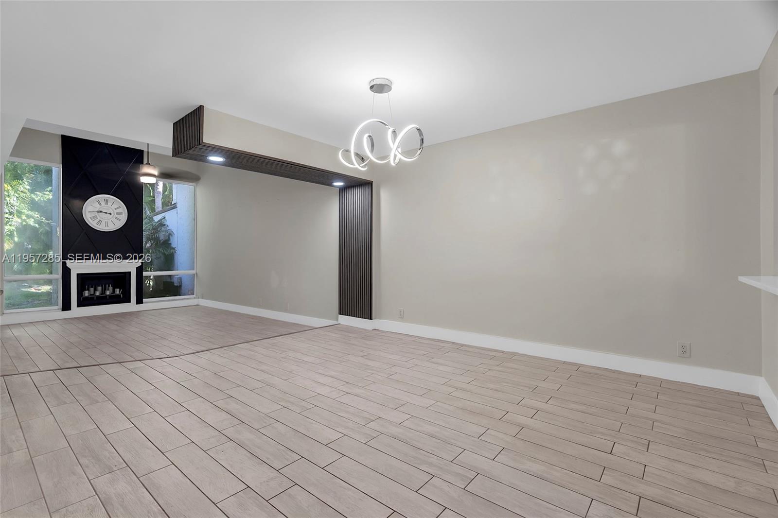 6768 Canary Palm Circle Boca Raton, FL 33433 - Photo 8 of 39 an empty room with wooden floor entryway and windows