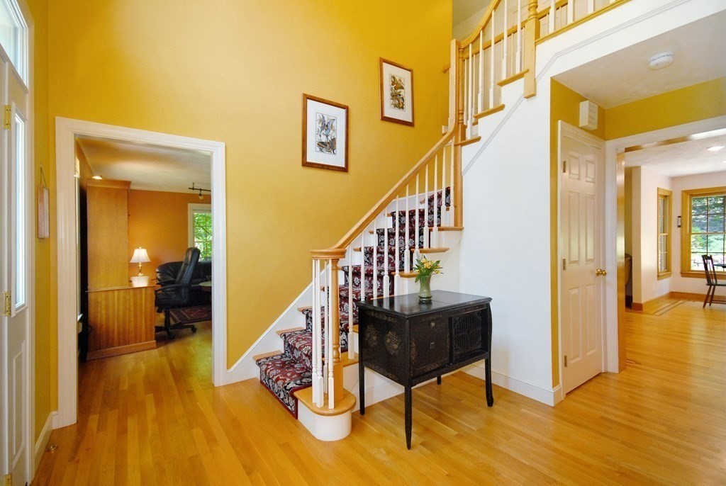 71 Whitcomb Road Boxborough, MA 01719 - Photo 18 of 31 a view of a hallway with wooden floor and furniture