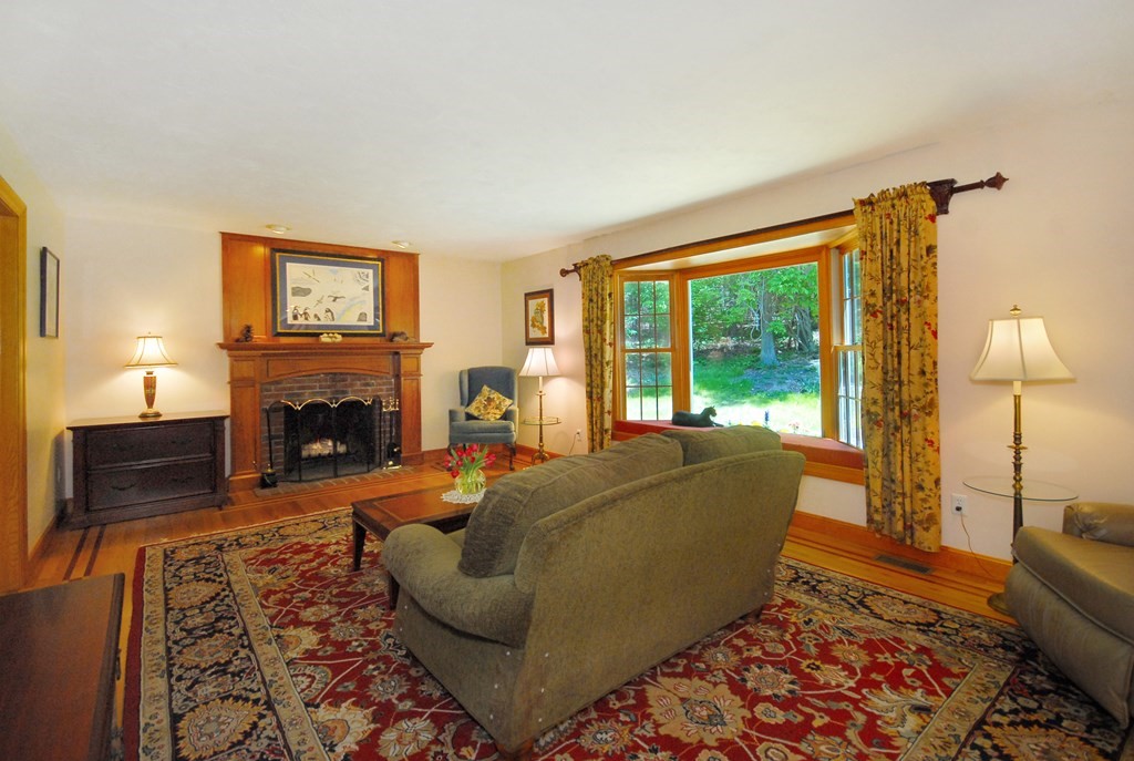 71 Whitcomb Road Boxborough, MA 01719 - Photo 8 of 31 a living room with furniture and a fireplace