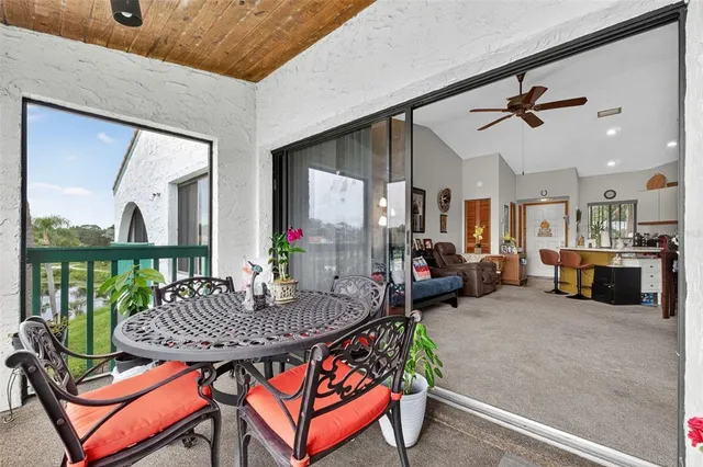 an aerial view of a houses with a yard and lake