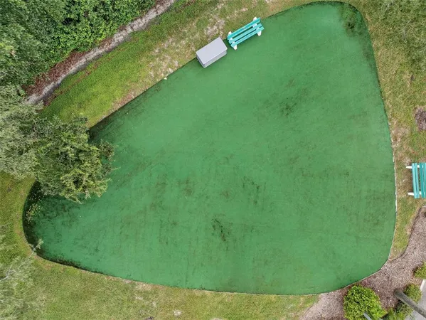 an aerial view of a houses with outdoor space swimming pool and outdoor seating