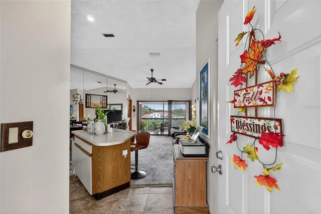 a kitchen with stainless steel appliances granite countertop a table chairs sink and cabinets