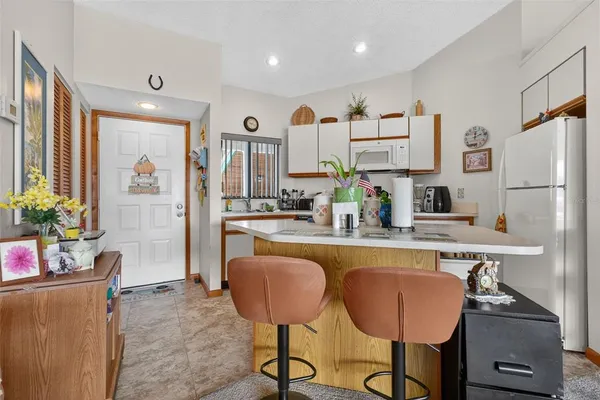 a kitchen with stainless steel appliances granite countertop a sink a stove and a refrigerator