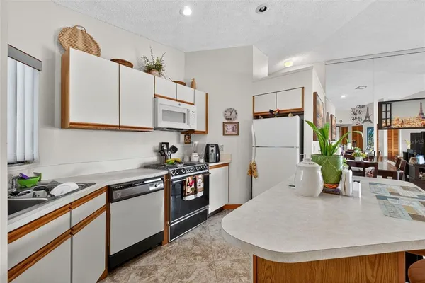 a kitchen with stainless steel appliances kitchen island granite countertop a sink and cabinets