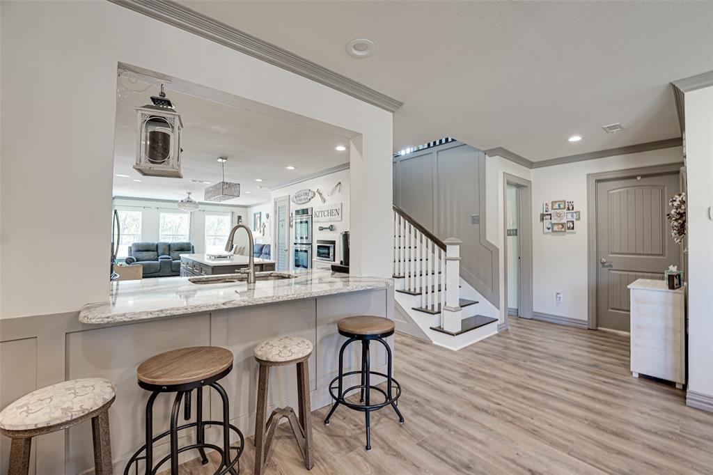 521 Bakers Branch Road Waxahachie, TX 75167 - Photo 13 of 37 Breakfast bar with a stone countertop and undermount sink