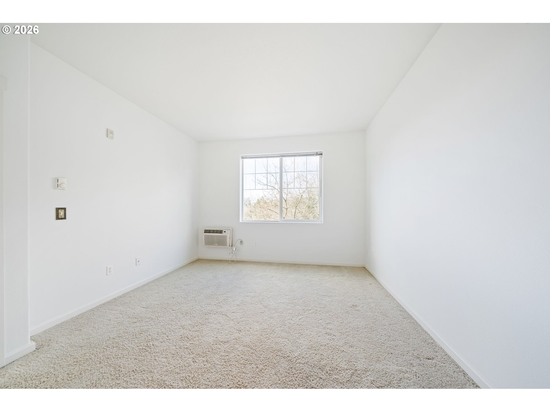 695 Northwest Falling Waters Lane, Unit 304 Portland, OR 97229 - Photo 13 of 25 a view of an empty room with a window