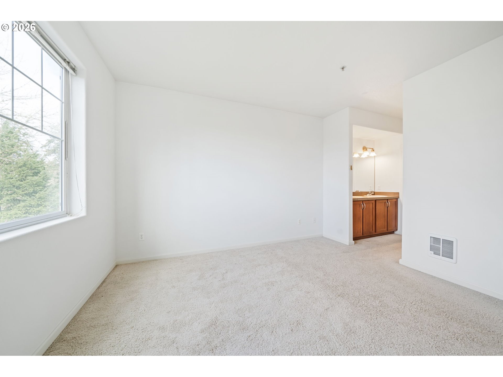 695 Northwest Falling Waters Lane, Unit 304 Portland, OR 97229 - Photo 14 of 25 a view of an empty room and window