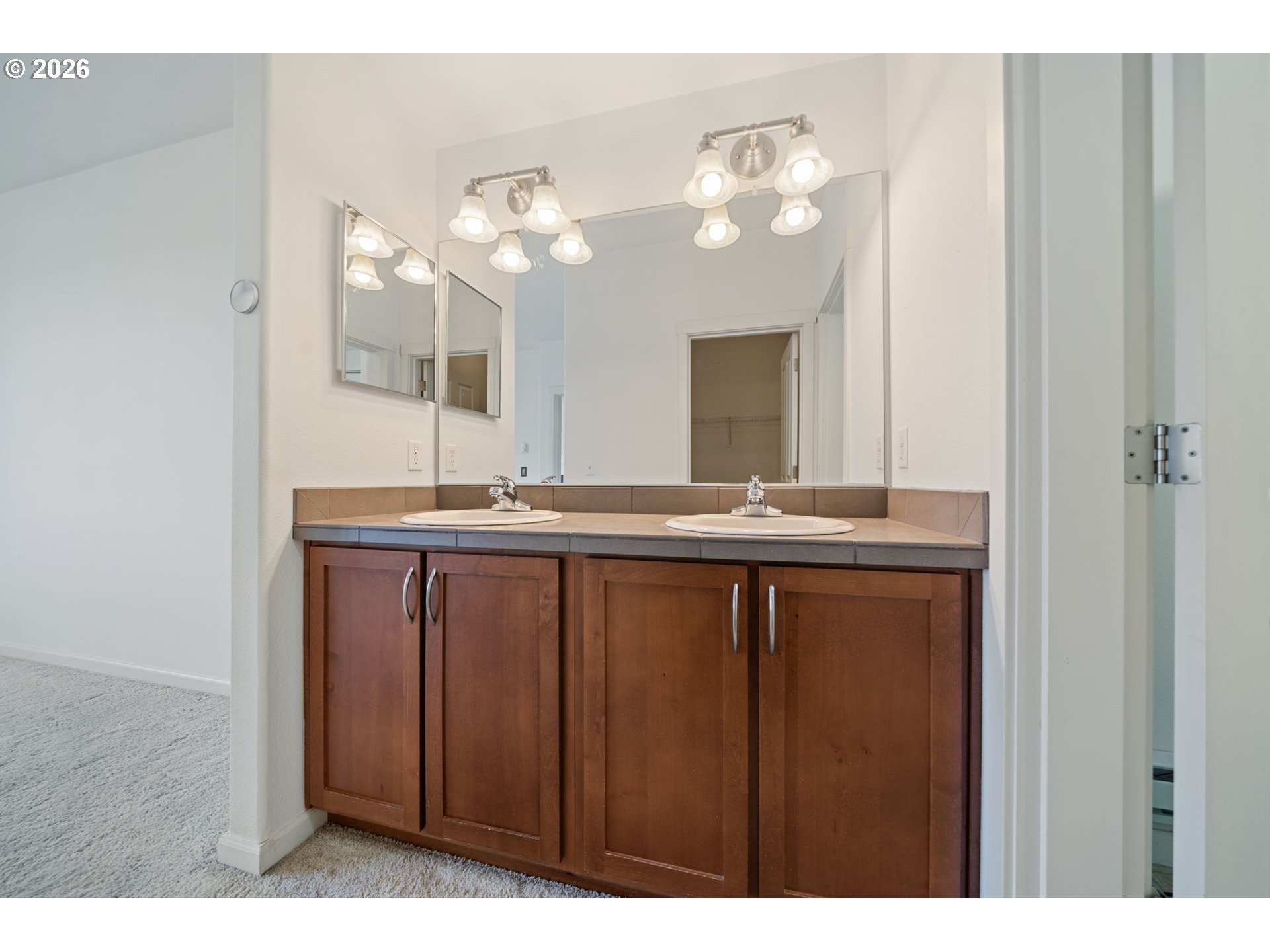695 Northwest Falling Waters Lane, Unit 304 Portland, OR 97229 - Photo 15 of 25 a bathroom with a sink vanity and a mirror