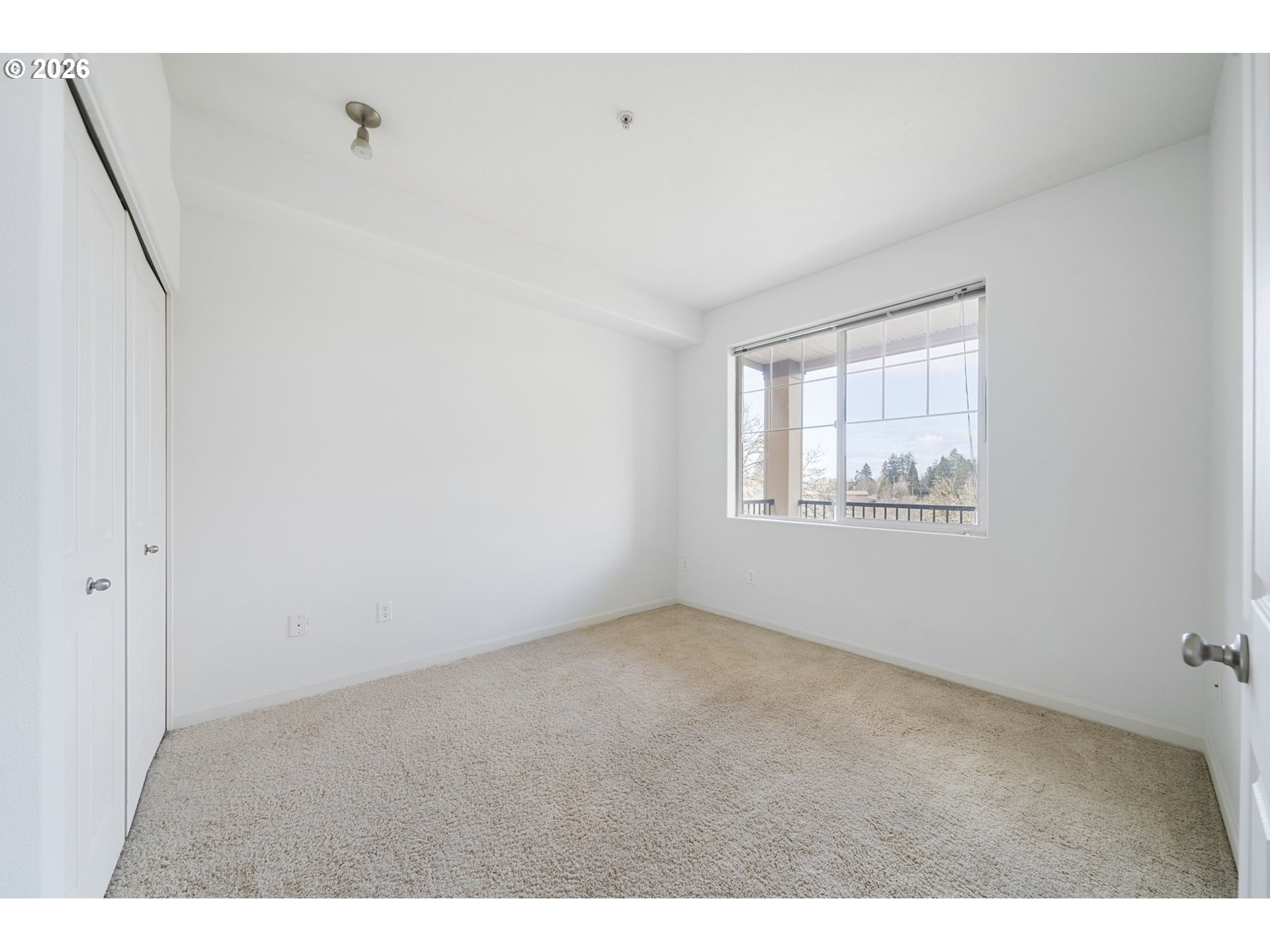 695 Northwest Falling Waters Lane, Unit 304 Portland, OR 97229 - Photo 19 of 25 a view of an empty room with a window