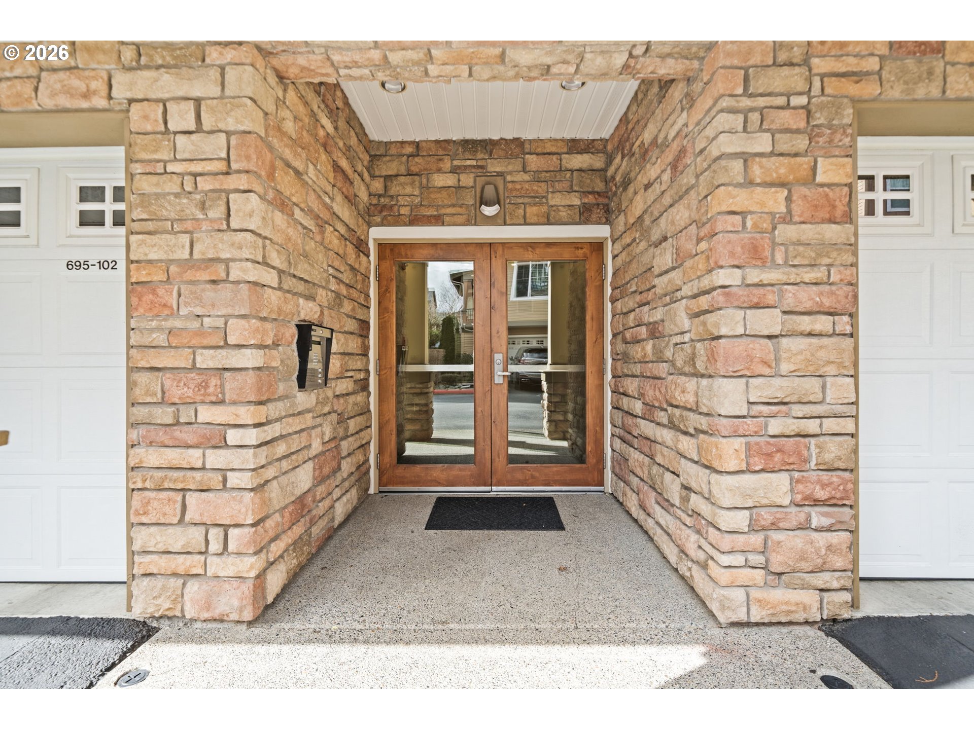 695 Northwest Falling Waters Lane, Unit 304 Portland, OR 97229 - Photo 2 of 25 front view of a brick house with a large window