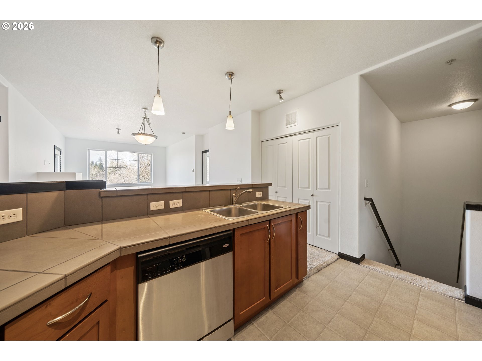 695 Northwest Falling Waters Lane, Unit 304 Portland, OR 97229 - Photo 10 of 25 a kitchen that has a sink a stove and a refrigerator
