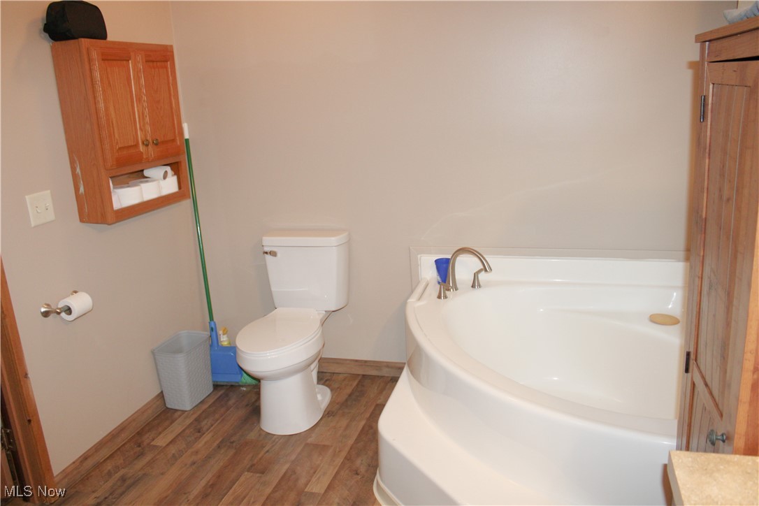 56 3rd Street Rayland, OH 43943 - Photo 20 of 46 Full bathroom with a bath, wood finished floors, and vanity