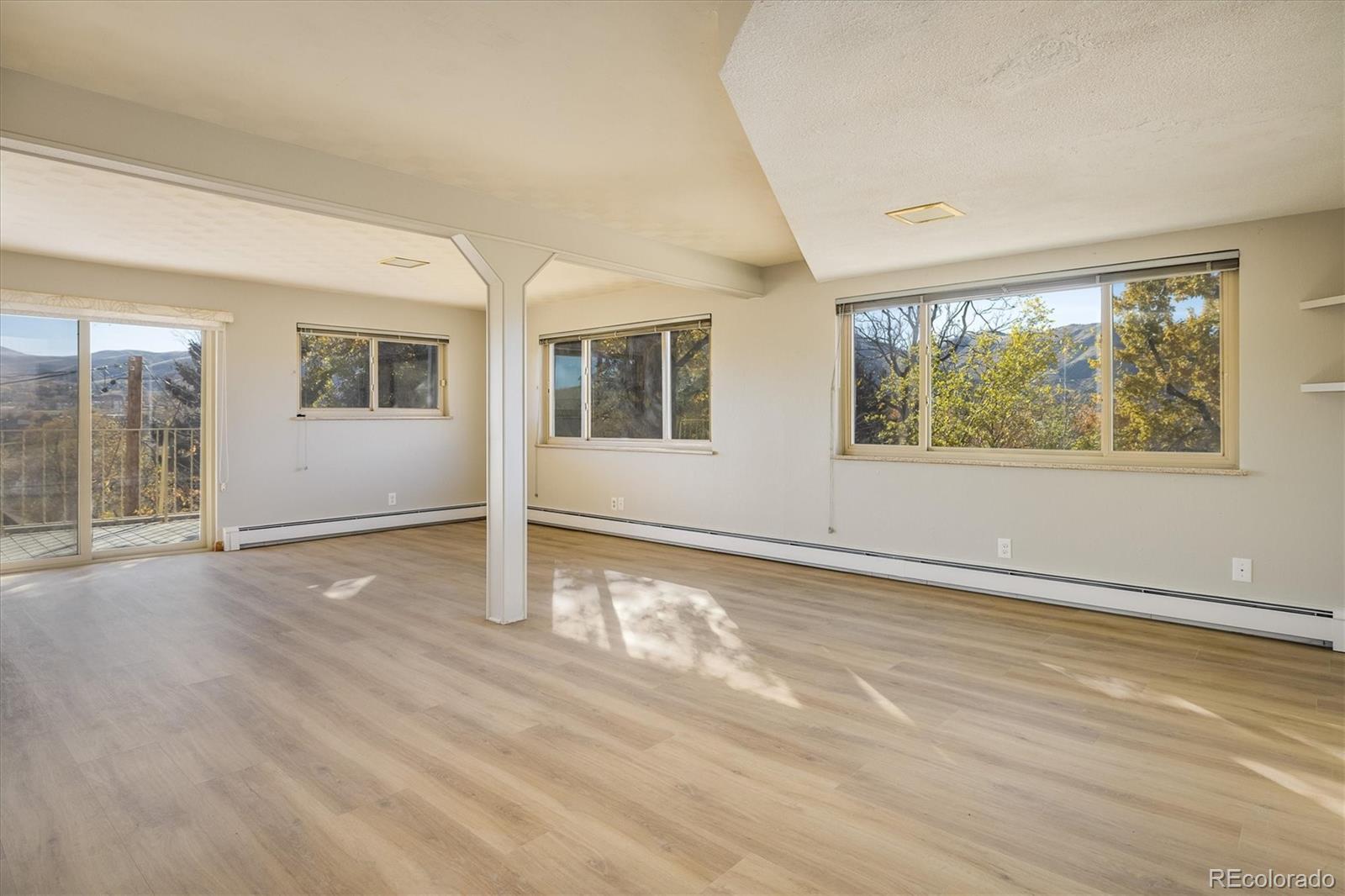 215 Lookout View Court Golden, CO 80401 - Photo 12 of 37 a view of an empty room with wooden floor and a window
