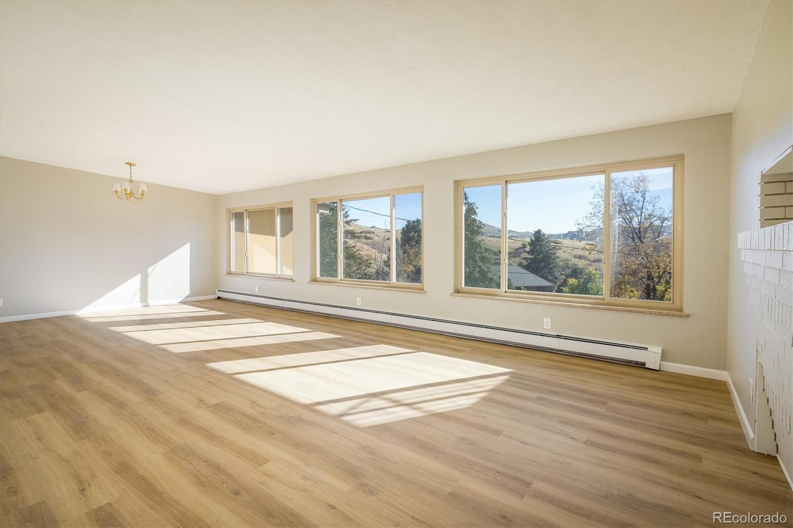 215 Lookout View Court Golden, CO 80401 - Photo 17 of 37 a view of an empty room with a window and wooden floor