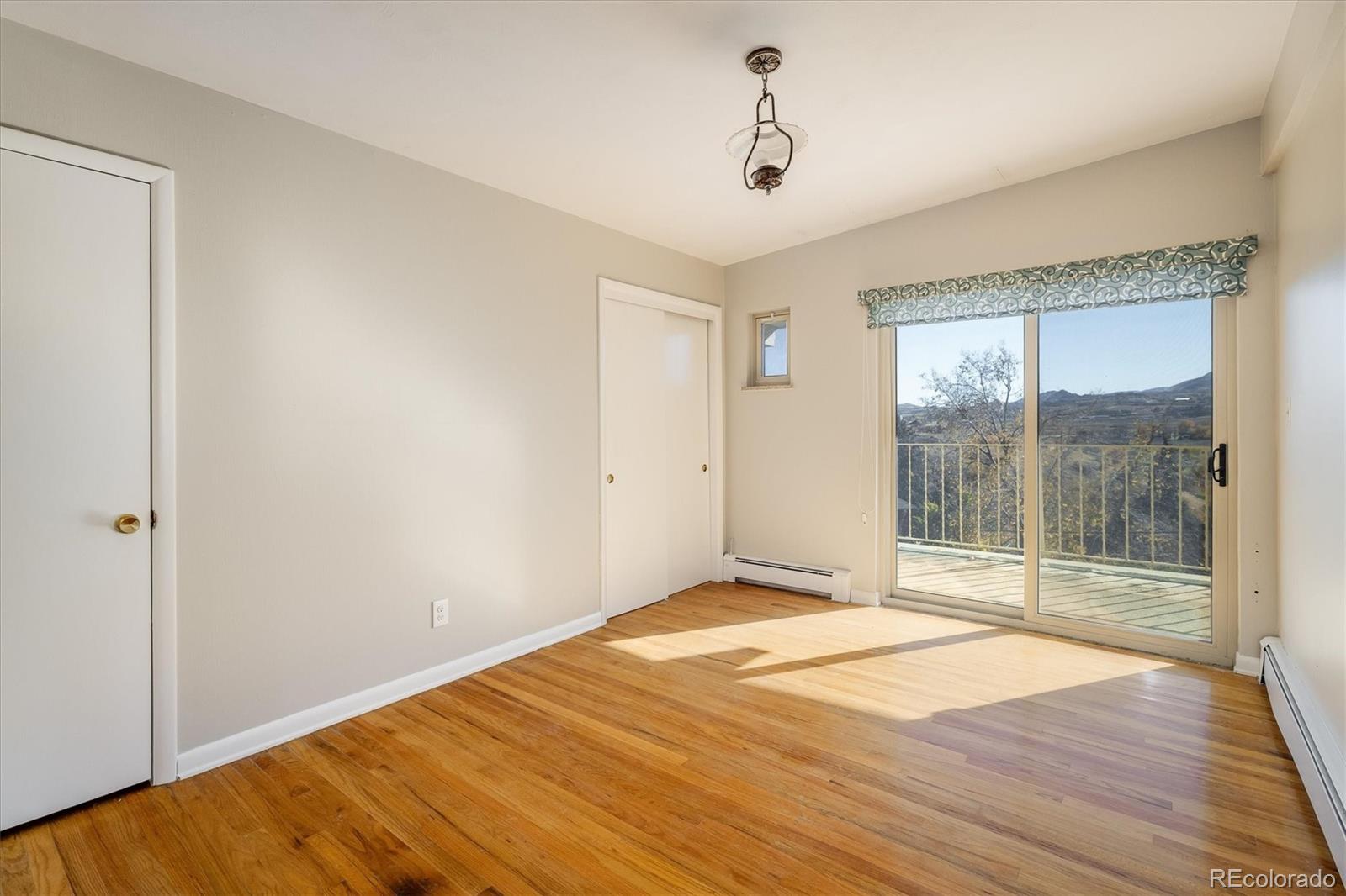 215 Lookout View Court Golden, CO 80401 - Photo 23 of 37 a view of a room with wooden floor and sliding door