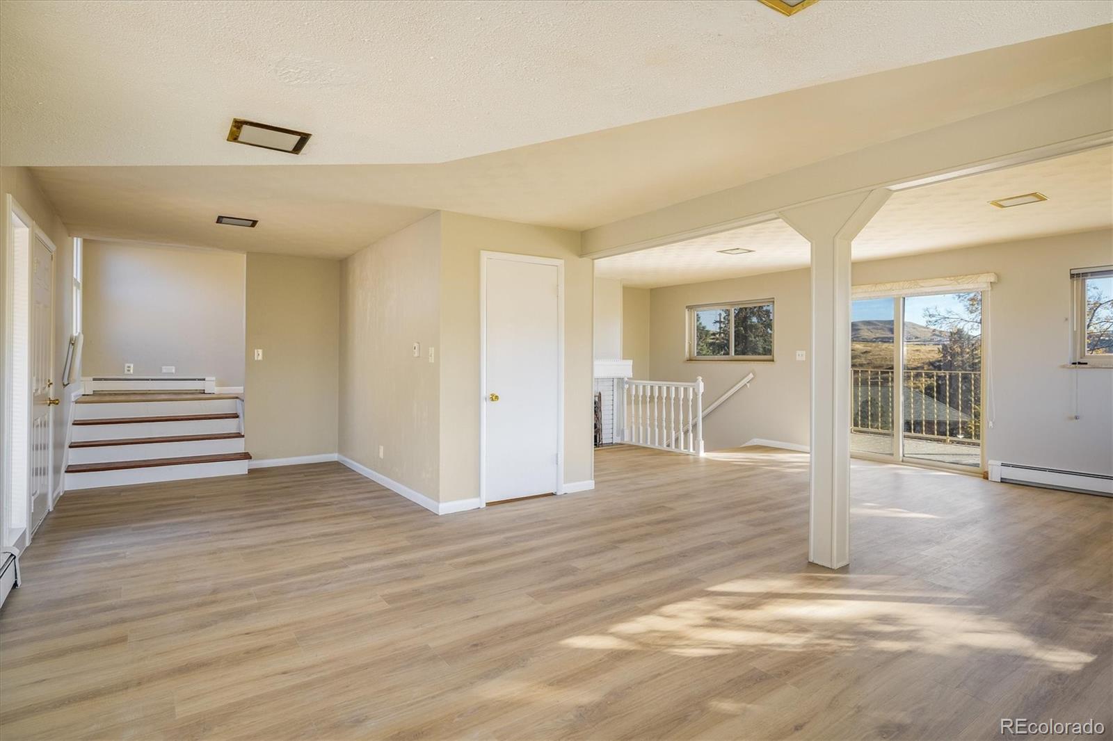 215 Lookout View Court Golden, CO 80401 - Photo 10 of 37 an empty room with wooden floor and windows