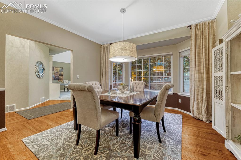 15585 Falcon Ridge Court Colorado Springs, CO 80921 - Photo 12 of 50 a view of a dining room with furniture window and wooden floor