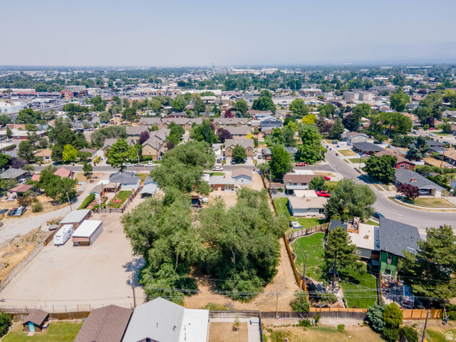 120 Cox Lane Midvale, UT 84047 - Photo 8 of 13 Aerial perspective showcasing a residential neighborhood with a mix of established homes and mature trees