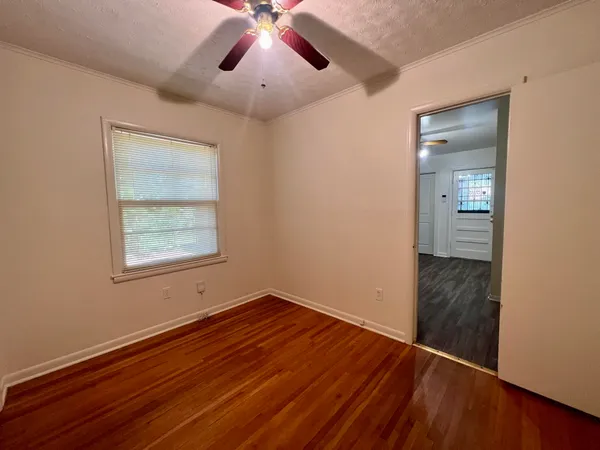 wooden floor in an empty room with a window
