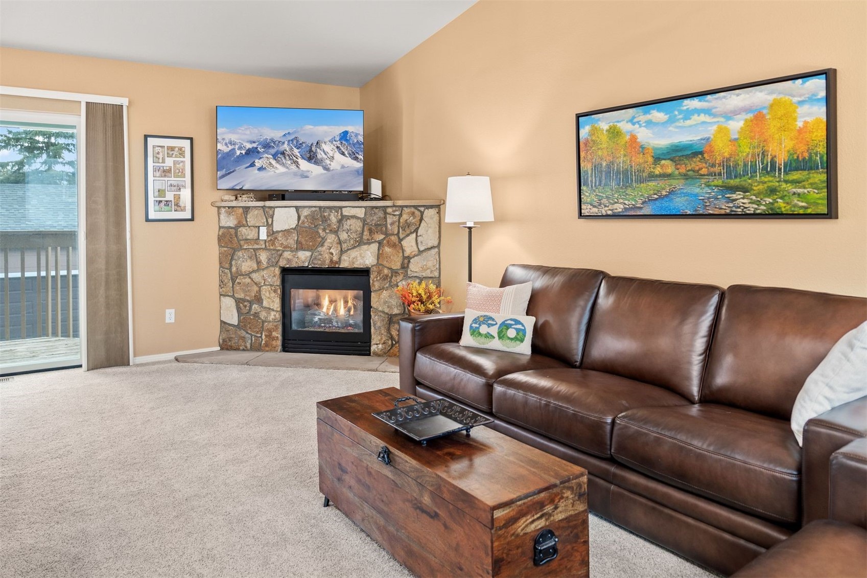 588 Alpine Road Dillon, CO 80435 - Photo 9 of 41 Carpeted living room with a stone fireplace