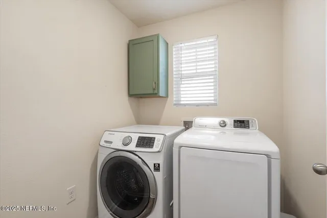 a utility room with dryer and washer