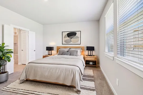 a bedroom with a bed and window