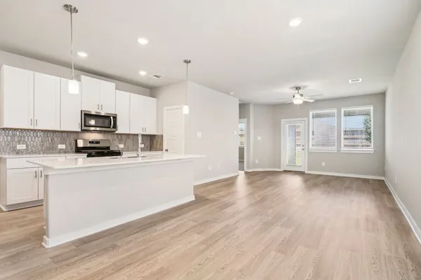 a large kitchen with hardwood floor and a sink