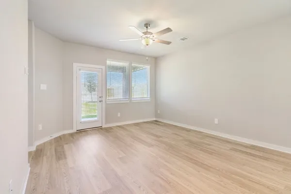 wooden floor in an empty room with a window
