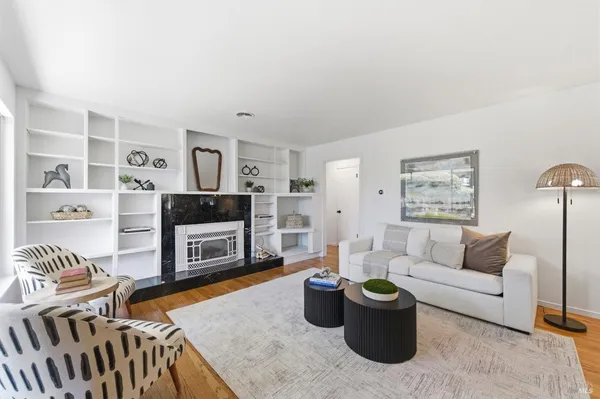 a living room with furniture and a fireplace