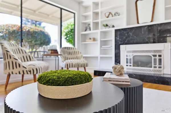 a living room with furniture a window and a table