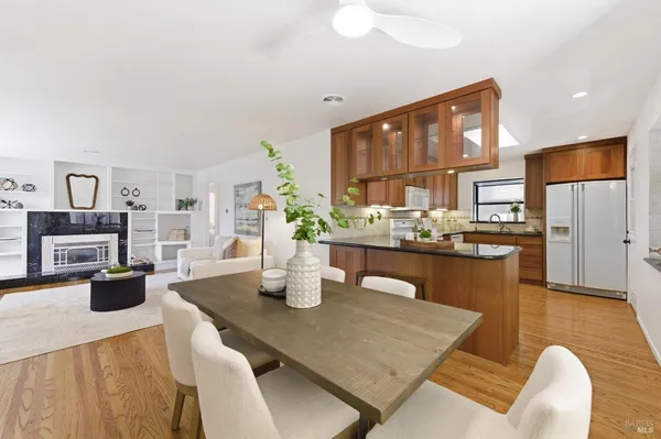 a living room with dining table and chairs