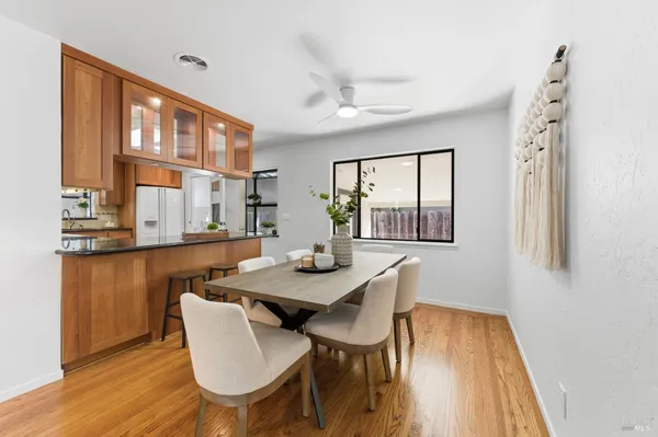 a view of a dining room with furniture and wooden floor