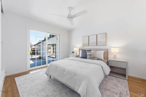 a bedroom with a large bed and a chandelier