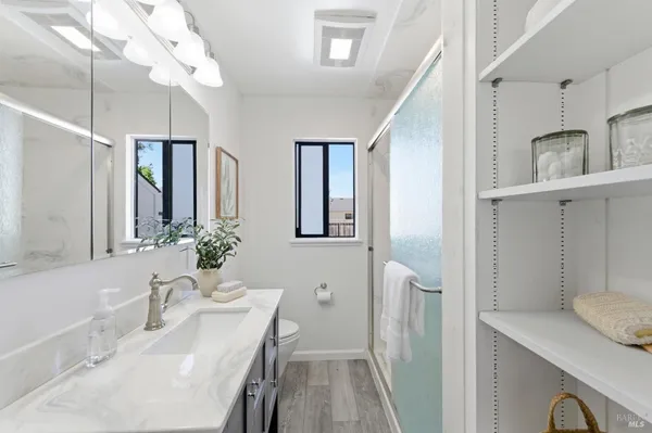 a bathroom with a granite countertop sink vanity granite and toilet