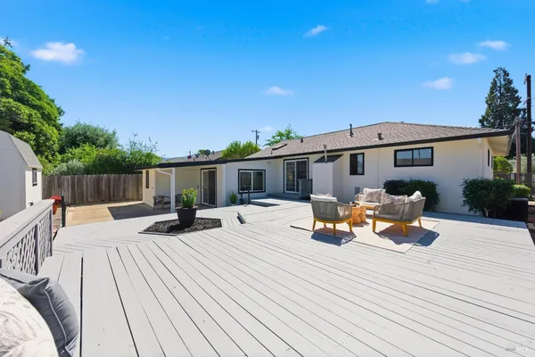 a view of a patio with table and chairs and wooden floor