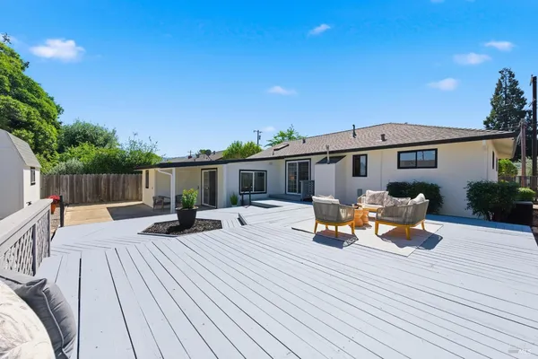a view of a house with backyard and sitting area