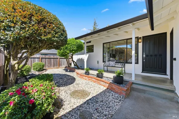a view of a house with backyard and sitting area