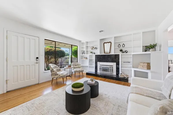 a living room with furniture a window and a fireplace