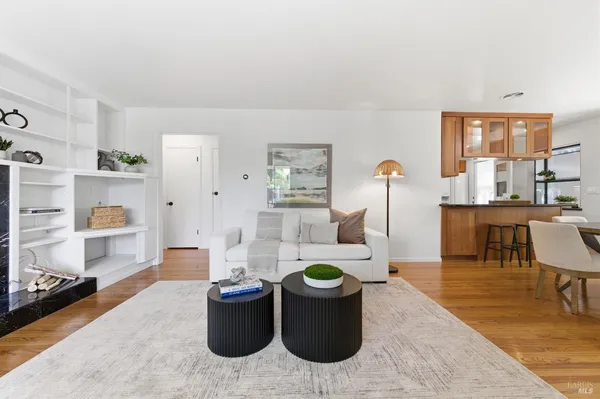 a living room with furniture a rug and a fireplace