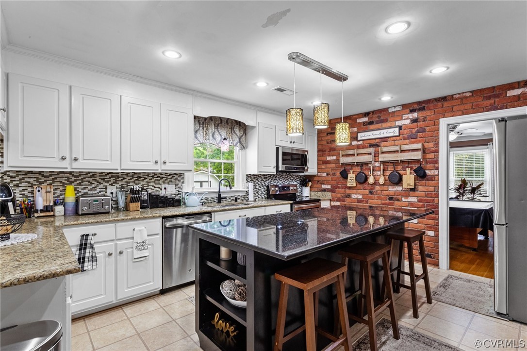 3905 Cresthill Road Chester, VA 23831 - Photo 12 of 49 a kitchen with stainless steel appliances granite countertop a stove top oven a sink dishwasher and cabinets with wooden floor